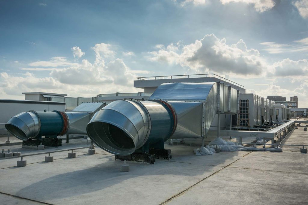 Two Industrial Blowers outside with a clear sky in background.