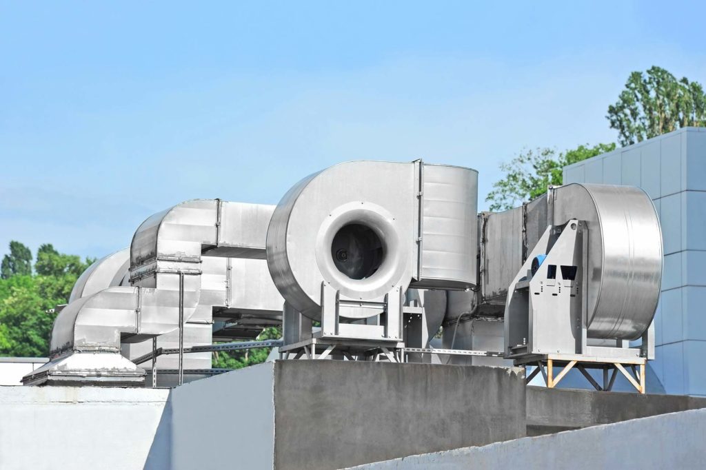 An image of an industrial blower outside on top of a building.