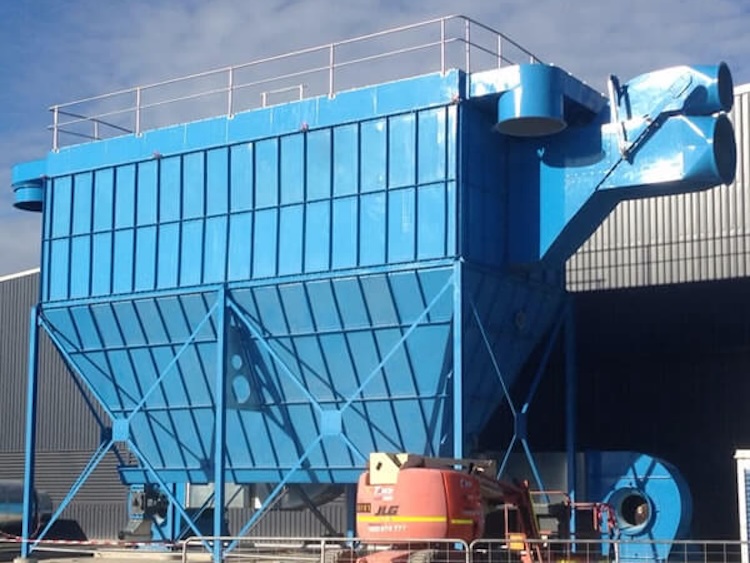 Blue dust collector outside of an industrial facility.